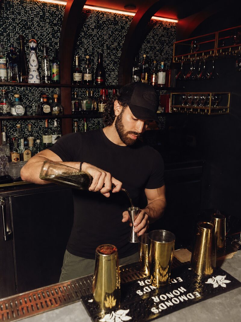 Andres Perlaza, founder of Groovys Miami, pouring a cocktail